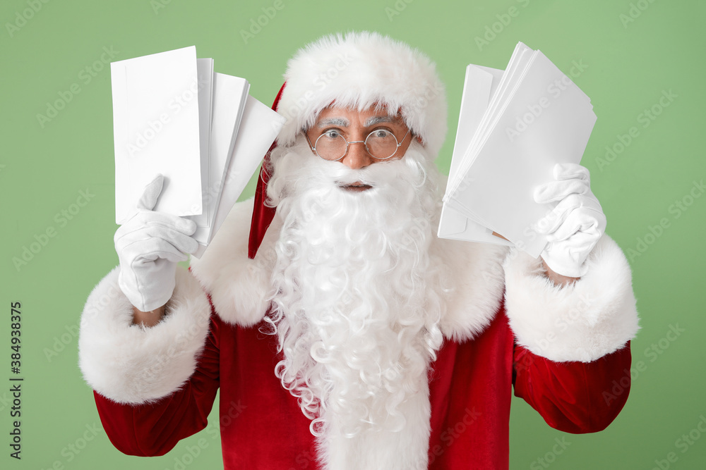 Santa Claus with letters on color background