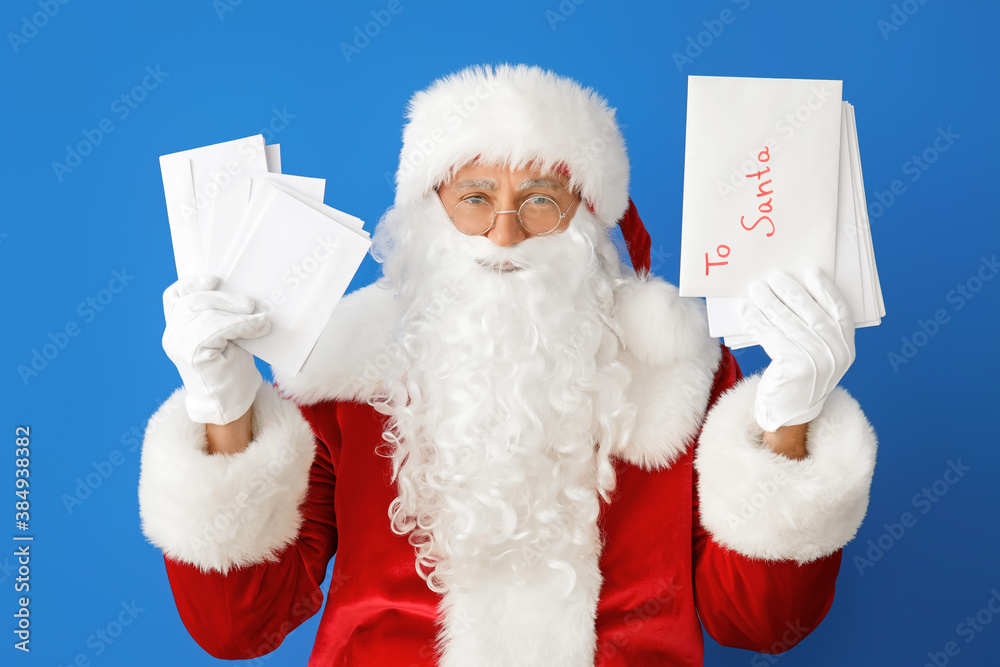 Santa Claus with letters on color background