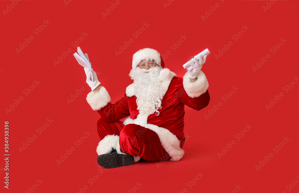 Santa Claus with letters on color background