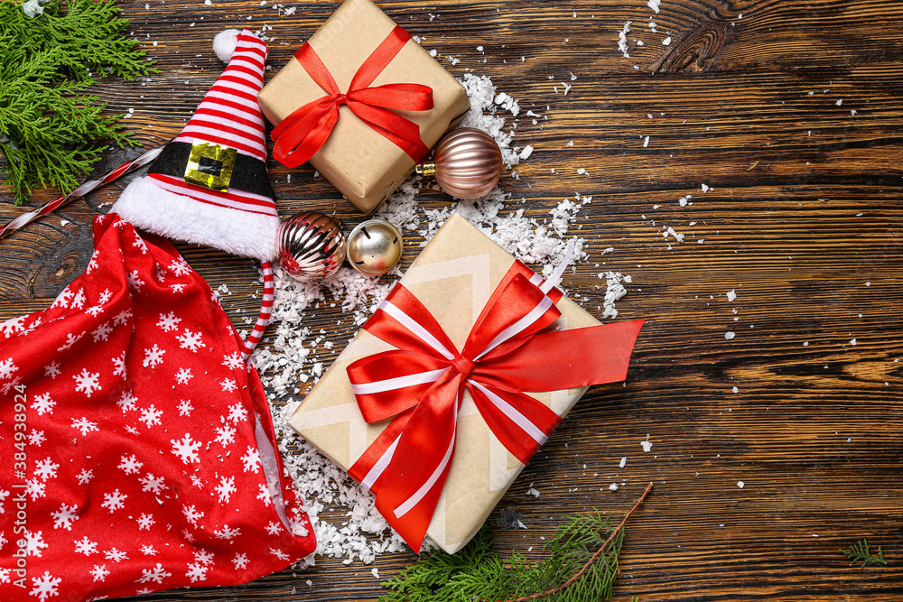 Santa bag with gifts on wooden background