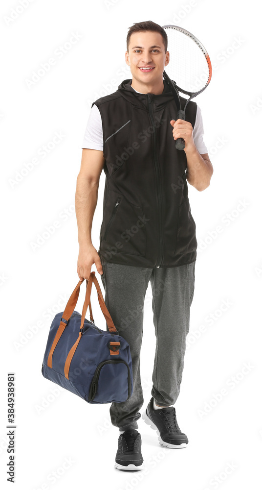 Sporty young man with bag and tennis racket on white background