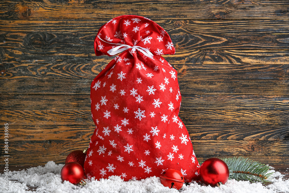 Santa bag with gifts and decor on wooden background