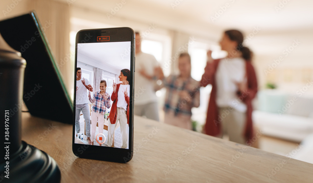 Family recording social media content on phone