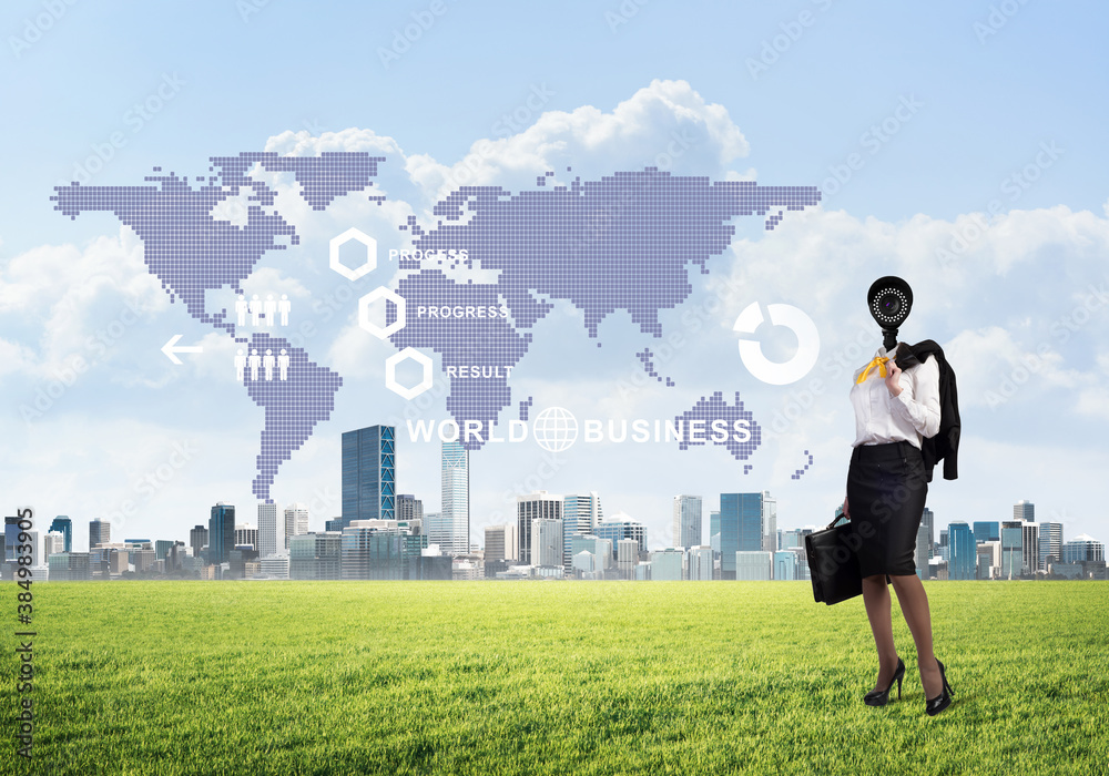 Camera headed woman standing on green grass against modern cityscape