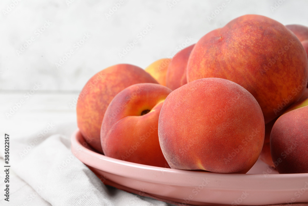 Plate with sweet peaches on table, closeup