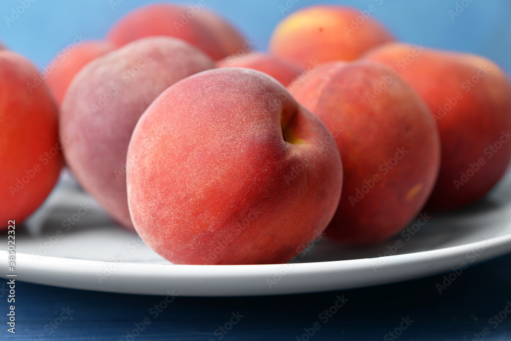 Plate with sweet peaches on table, closeup