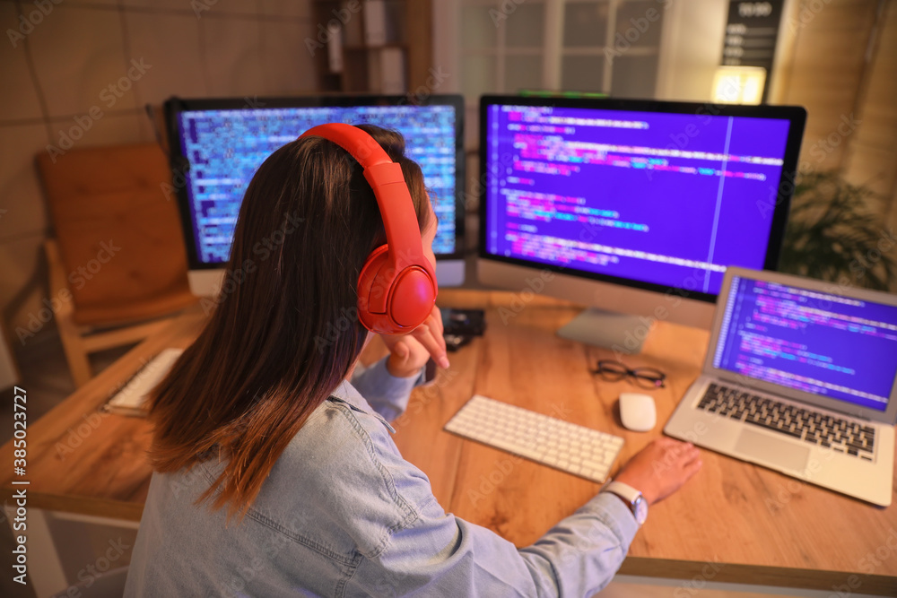 Female programmer working in office at night