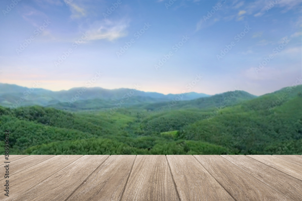 Empty wooden table top with blur mountain background.