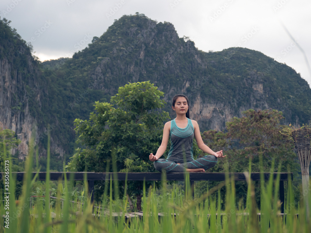 woman doing yoga in the morning , healthy woman practicing yoga, a yoga to relax outdoor