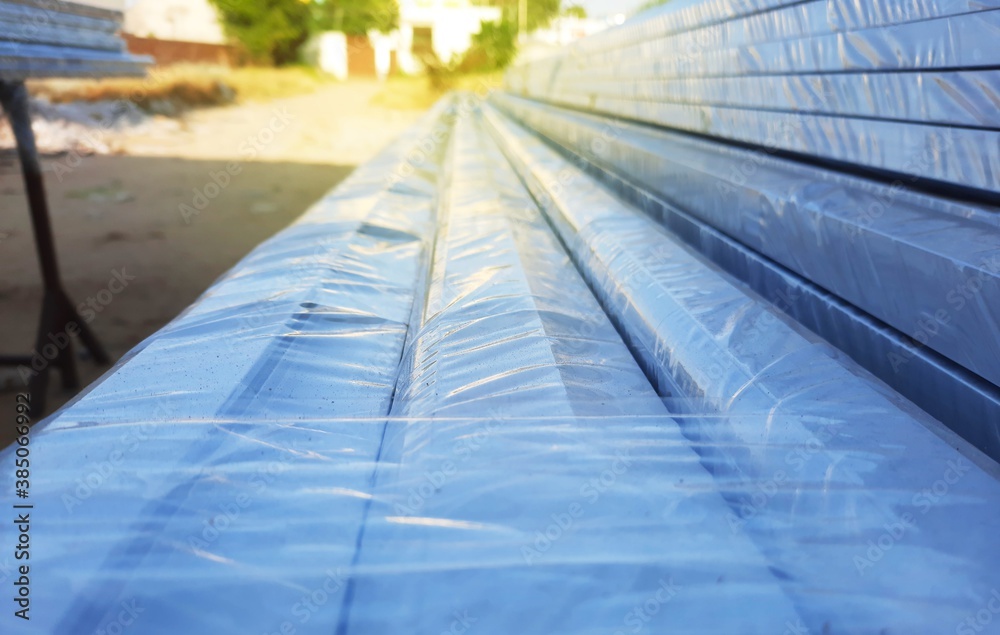 Anodized aluminium metal frames wrapped in polythene in a factory