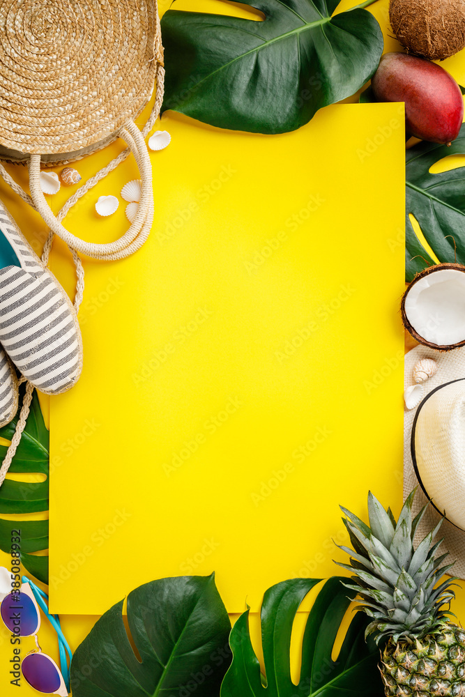 Straw hat, camera, bag, summer shoes, sunglasses, shells, tropical leaves and fruits over yellow bac