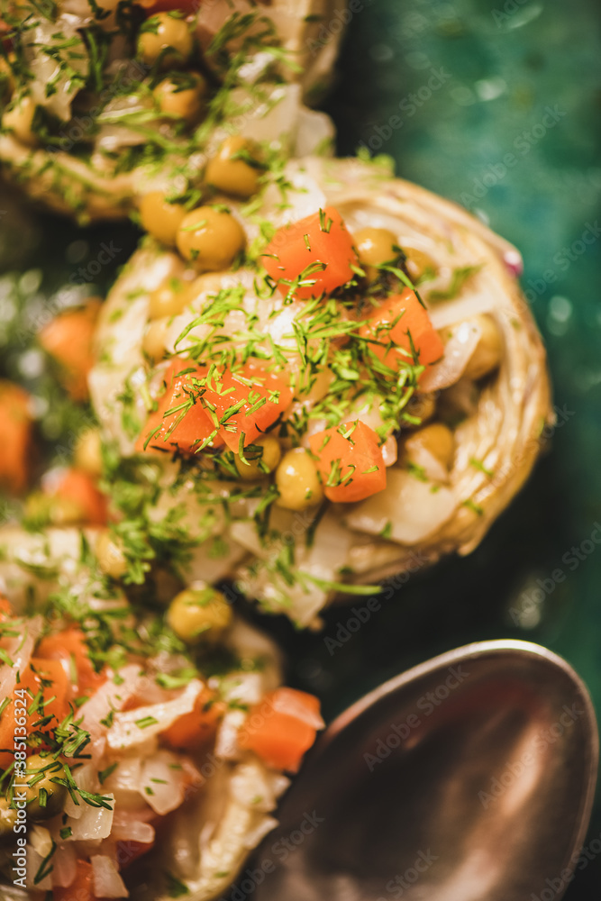 Turkish vegan artichoke salad. Artichoke bottoms filled with braised vegetables and greens with oliv