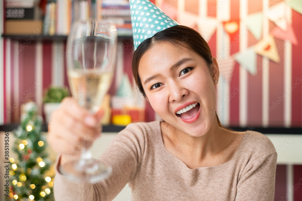 POV Asian woman holding wine glass to celebrate a party via video call conference, new normal for bi