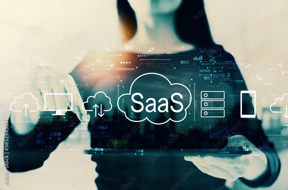 SaaS - software as a service concept with businesswoman on a city background