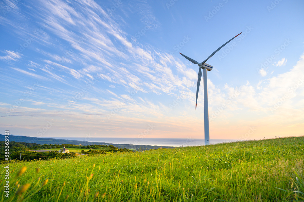 View of Wind turbine in glass field on hill