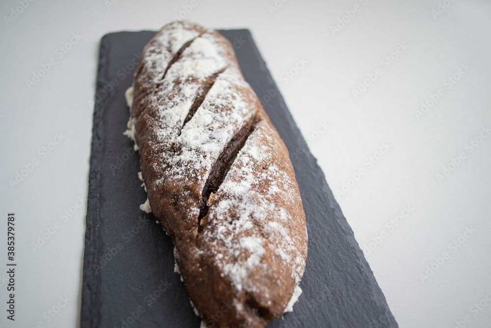 Artistic composition in natural light. Homemade rye mini baguette (the focus is specially placed in 