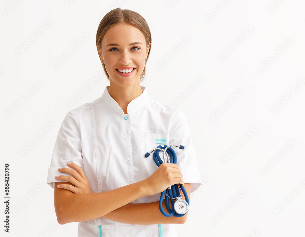 friendly doctor nurse in a blue uniform smiles in isolation against a white background.