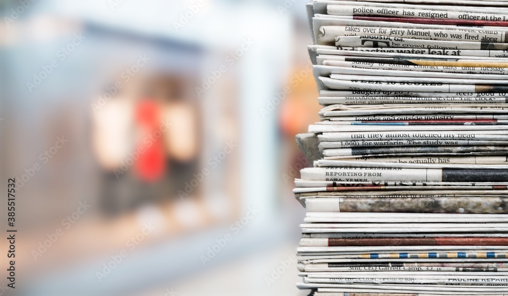 Pile of fresh newspapers on a blur background