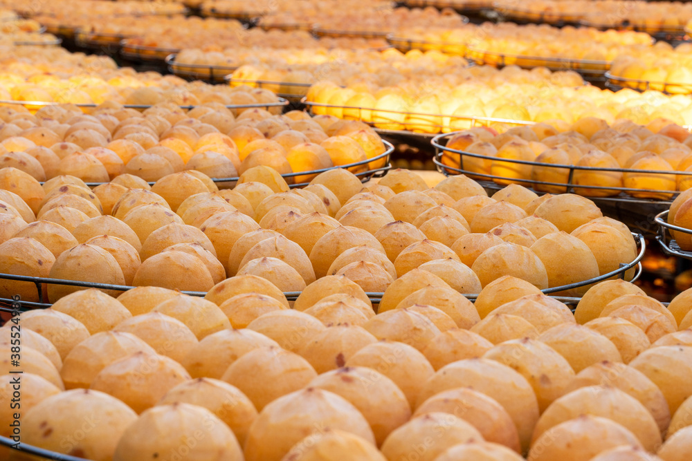 Making process of sun exposuring dried persimmon in a sieve in autumn.