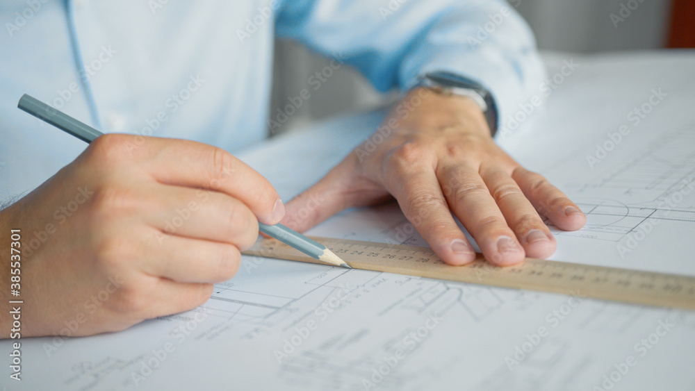 Engineers hands making a drawing