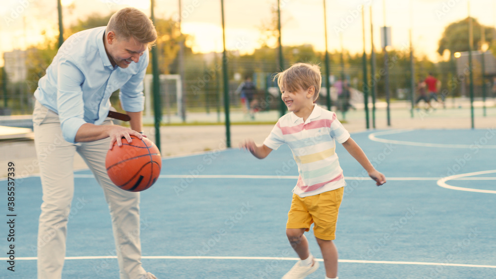 Father and son playing basketball on the court