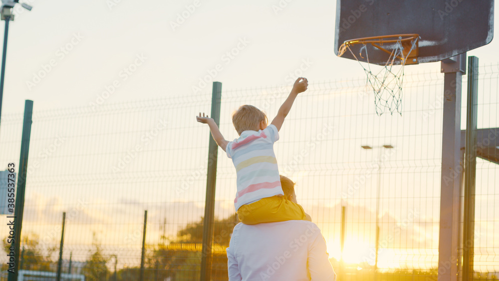 Family on the basketball court at sunset