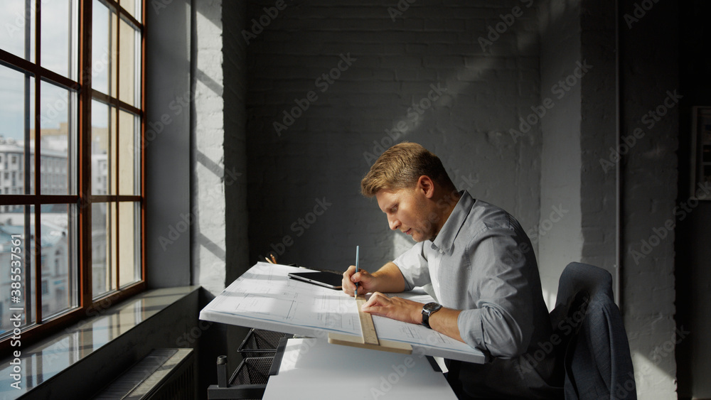 Working man with a plan at the desk