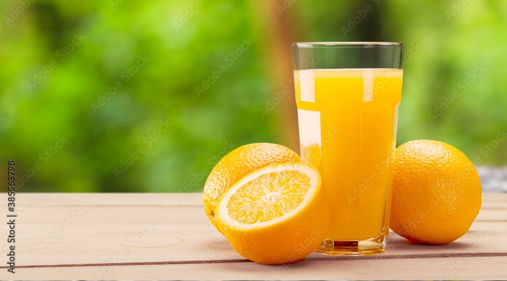 Orange juice and slices of orange on desk