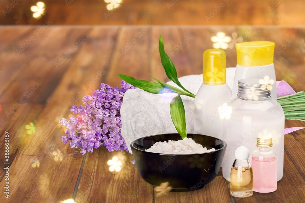 Pile of lavender flowers and a dropper bottle with lavender essence