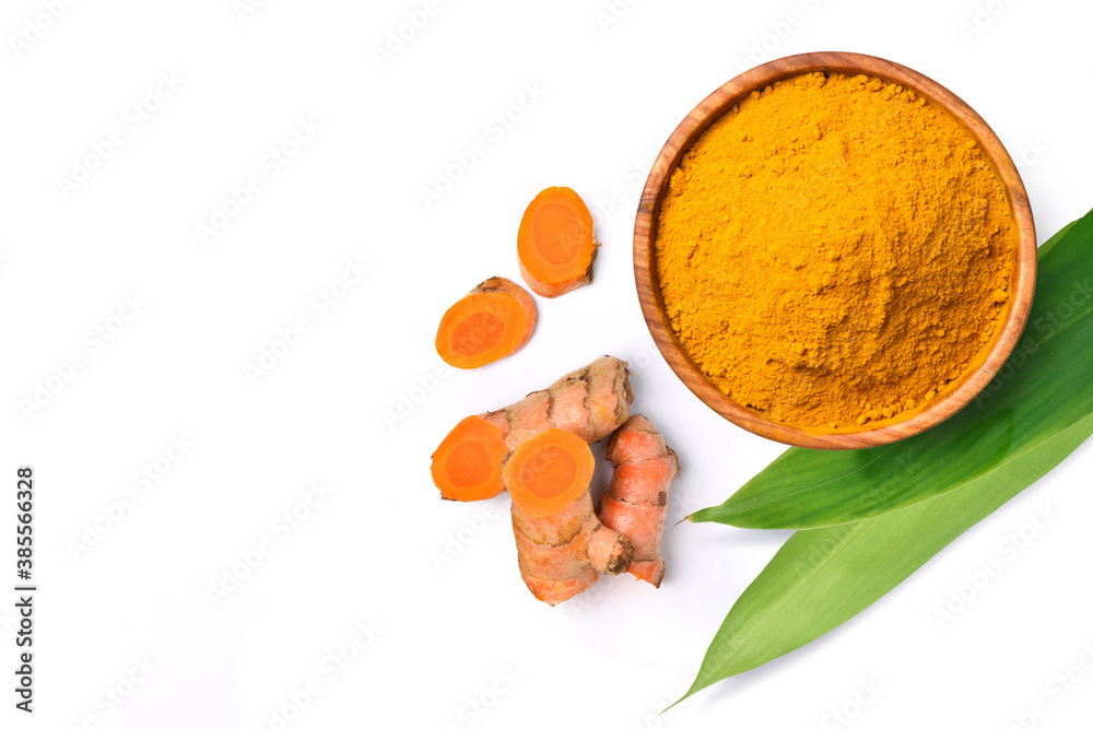 Flat lay (top view) of Finely dry Turmeric powder with  rhizome sliced and green leaves isolated on 