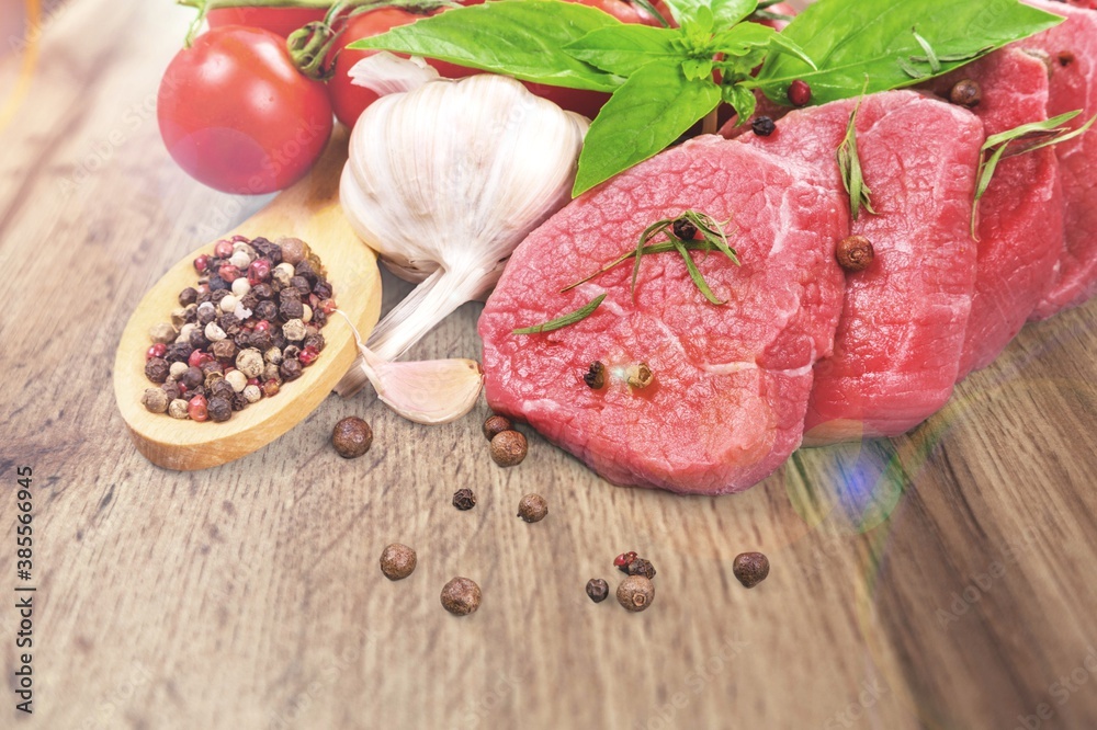 Collections fresh raw meat with spices on the desk