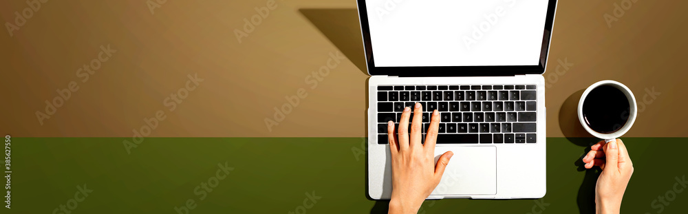 Person using a laptop computer from above