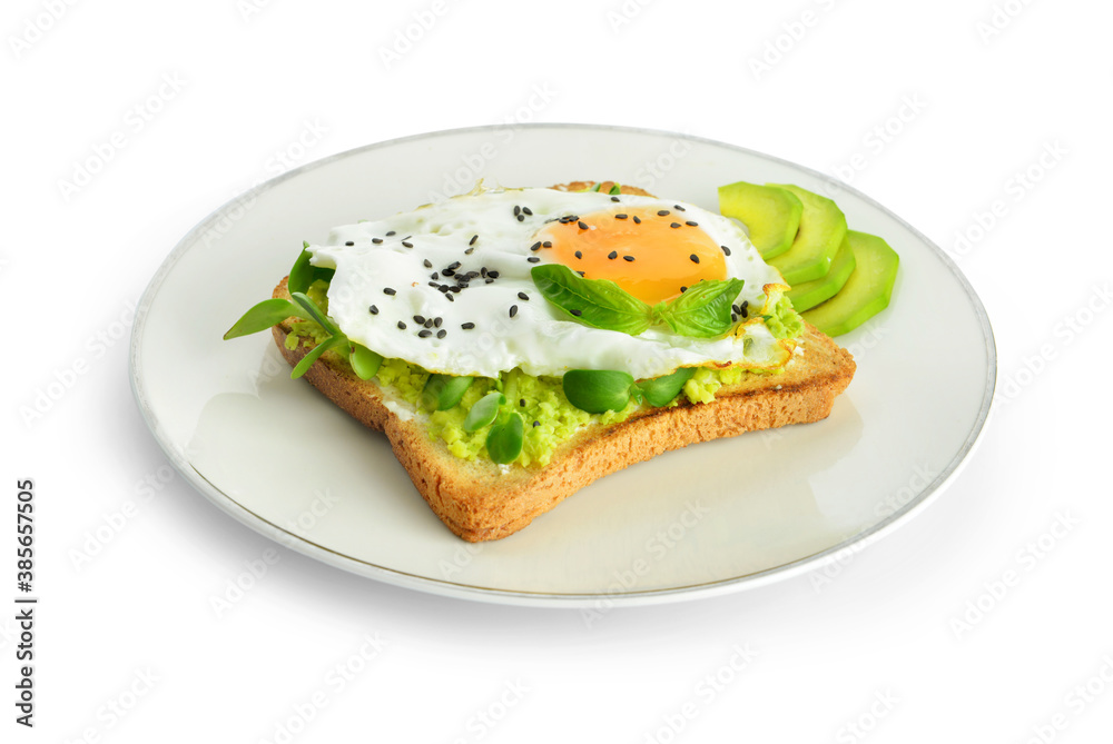 Sandwich with fried egg and avocado on plate against white background