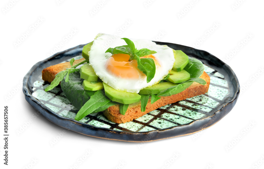 Sandwich with fried egg and avocado on plate against white background