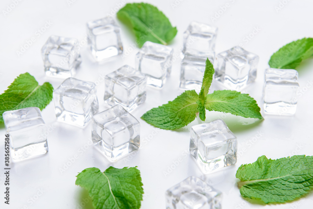 Ice cubes and mint on light background