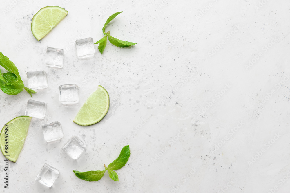 Ice cubes, mint and lime on light background