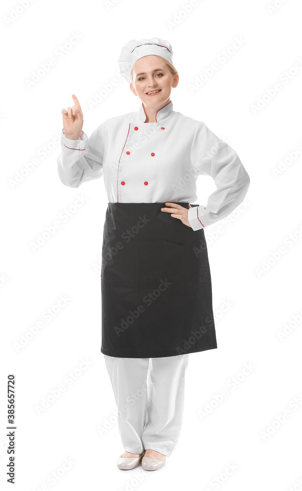 Mature female chef pointing at something on white background