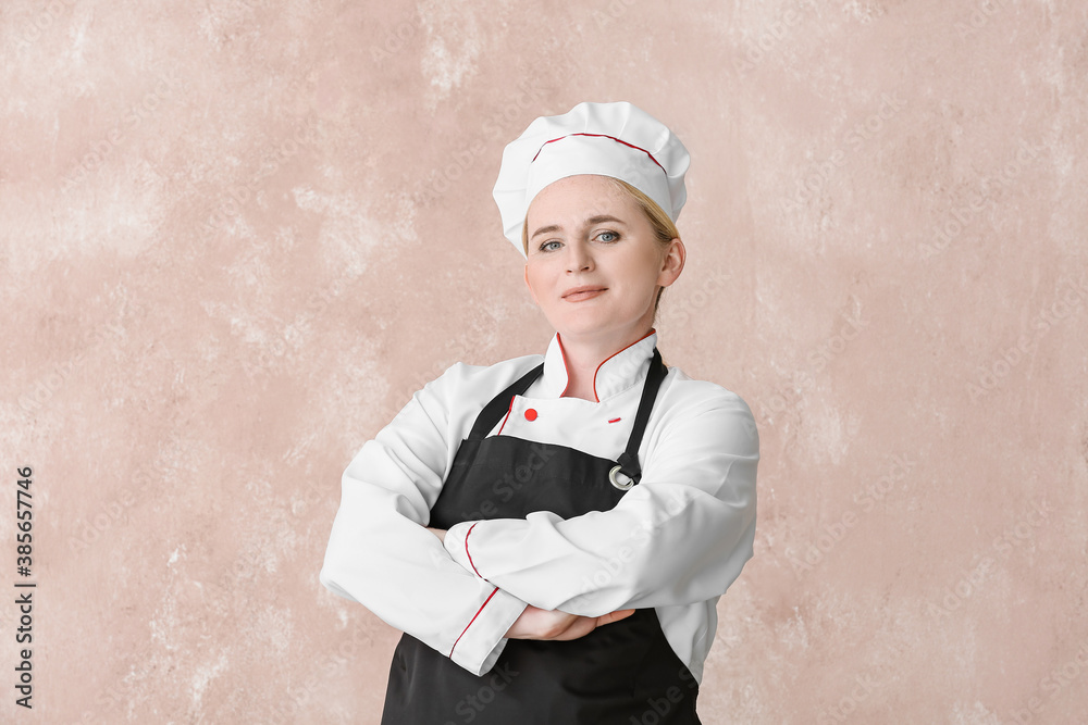 Mature female chef on color background