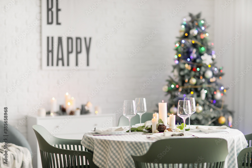 Interior of room with table set for Christmas dinner