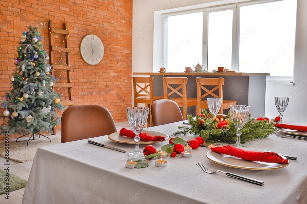 Interior of room with table set for Christmas dinner