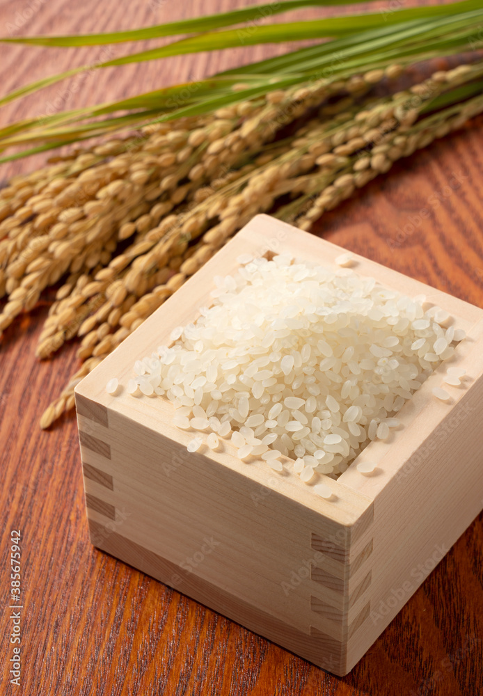 Rice in a Japanese Masu in a wooden background