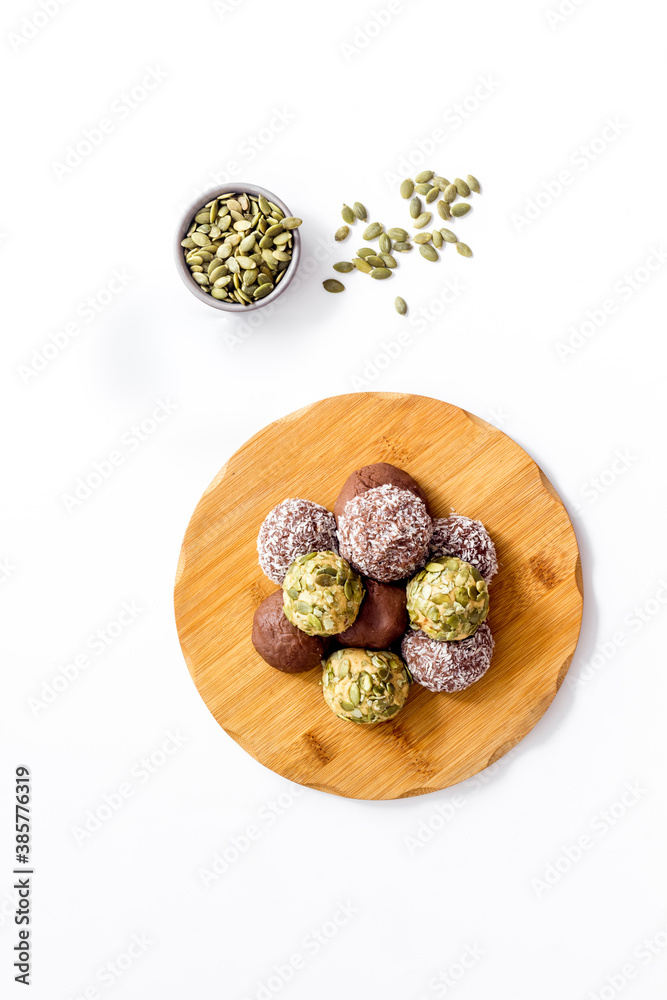 Vegen energy balls with pumpkin seeds and coconut, overhead view