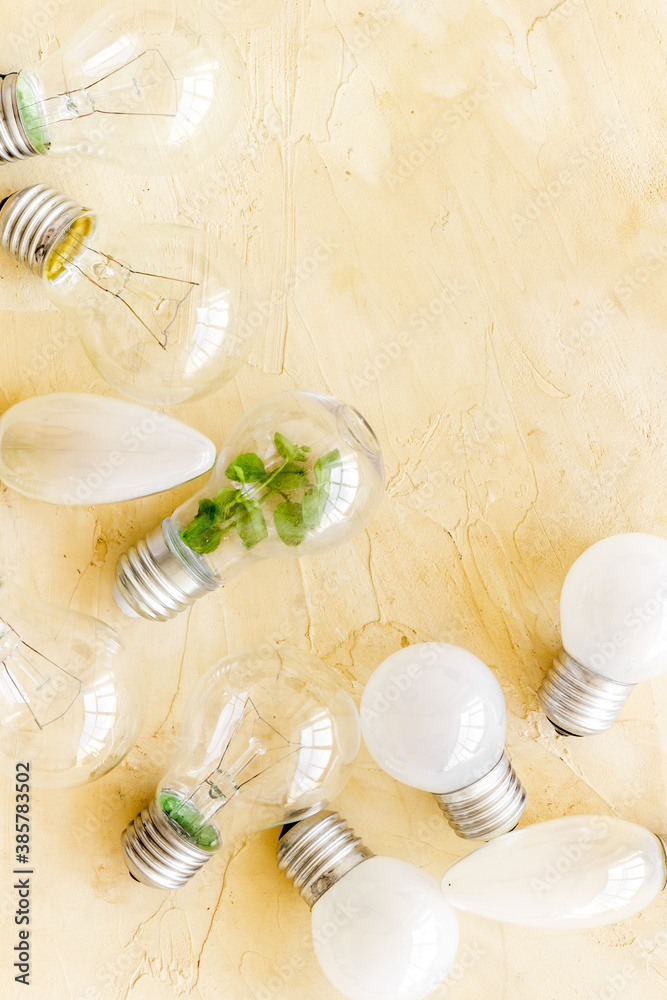 Renewable eco energy concept with light bulbs and green plant inside