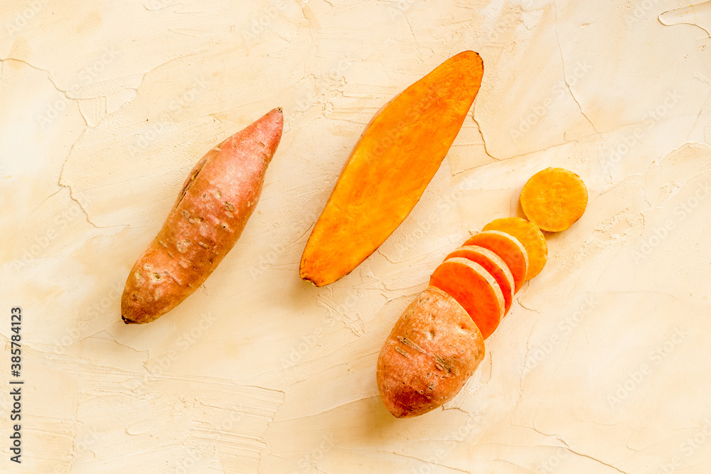 Set of whole and sliced sweet potatoes. Flat lay, top view