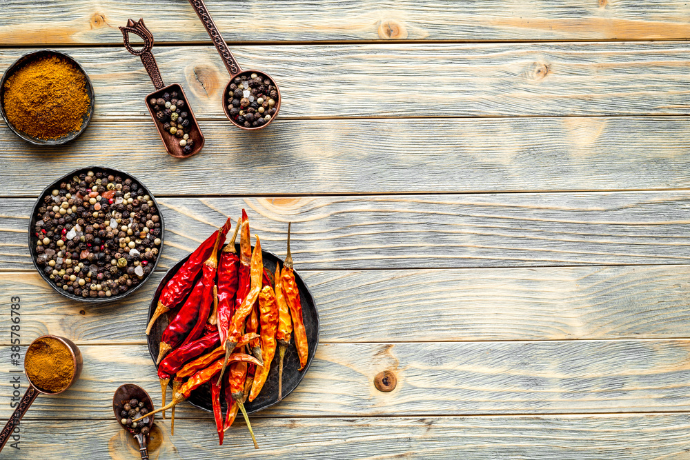 Spices and condiments in metal bowls and spoons. Overhead view