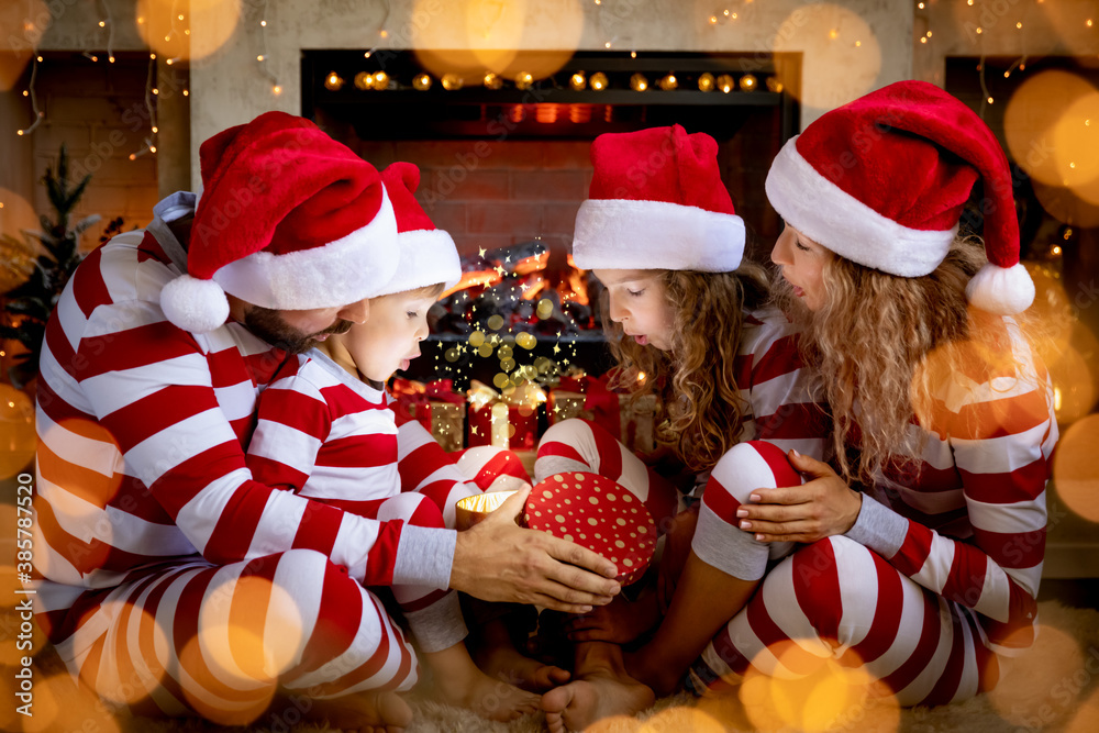 Happy family with children opening Christmas gift