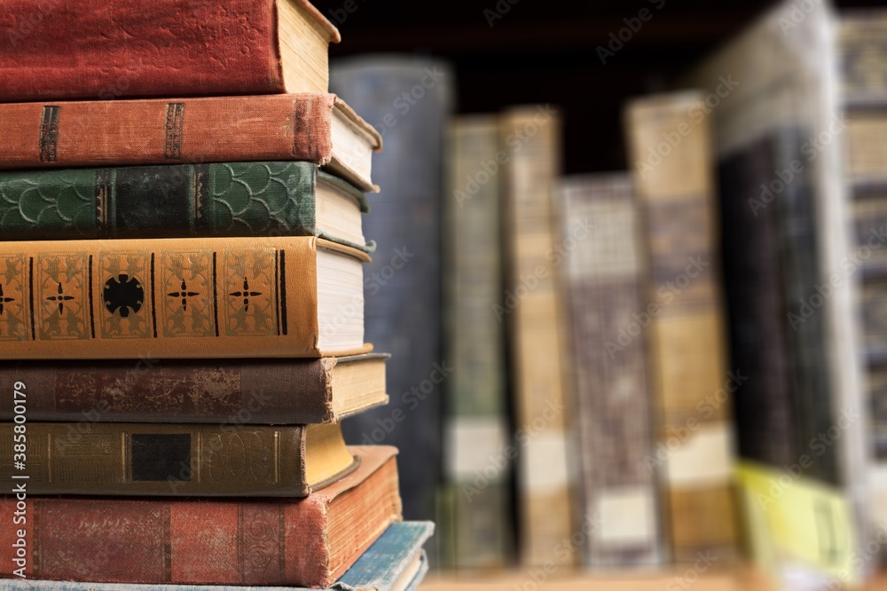 Collection of old books stack on shelf background