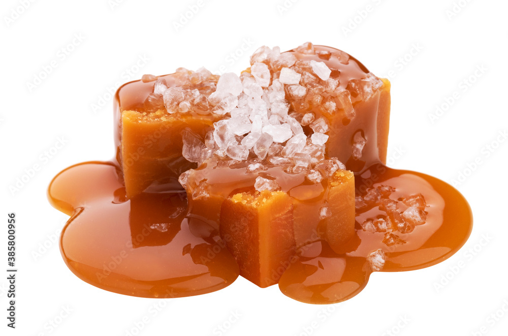 Toffee candies with caramel sauce and salt isolated on white background