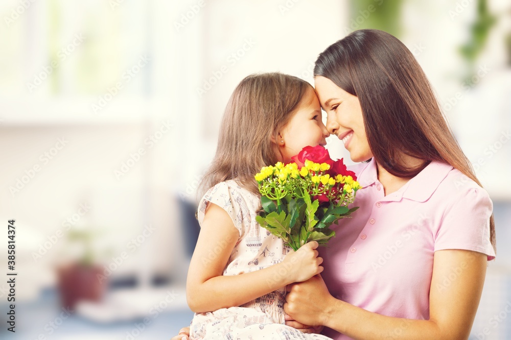 Happy Mother and daughter hugging with flowers