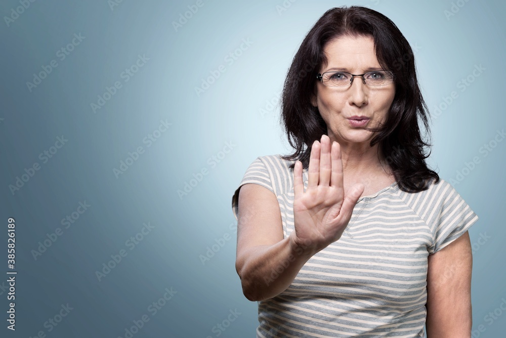 Middle-aged woman showing stop sign